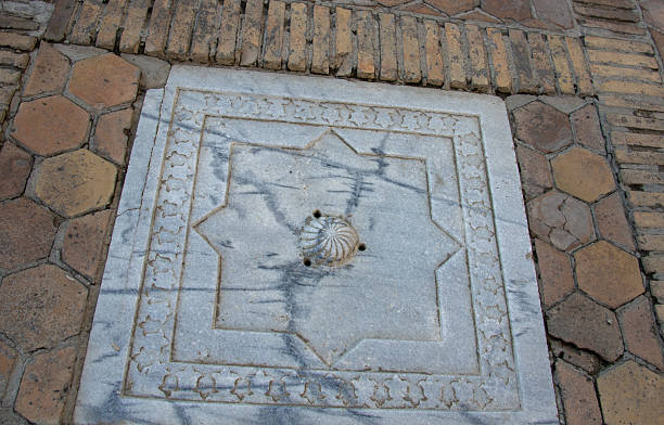 Marble slab with an eight-pointed star and vegetal border in the paving of Shah-i-Zinda, Samarkand